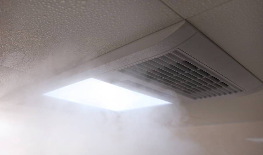 Moist air and steam being vented by a bathroom fan